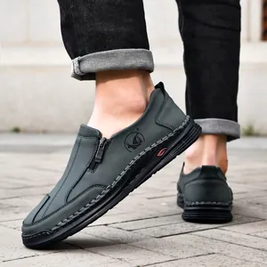 Close-up of men's dark grey hand-stitched casual leather shoes with side zipper.