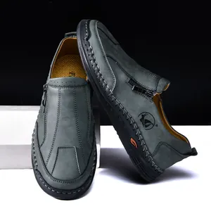 Detail shot of men's casual leather shoes with handmade stitching and side zipper.