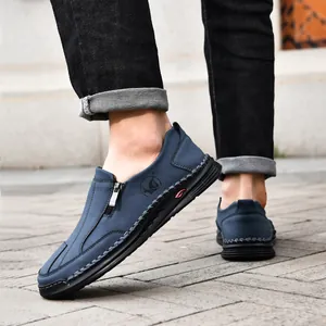 Close-up of navy blue men's casual loafers with side zipper and hand-stitched details