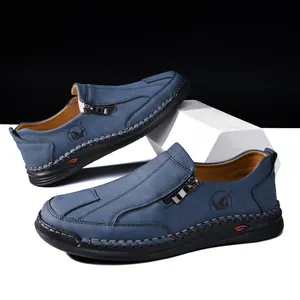 Detailed view of blue men's casual loafers featuring handmade stitching and side zipper