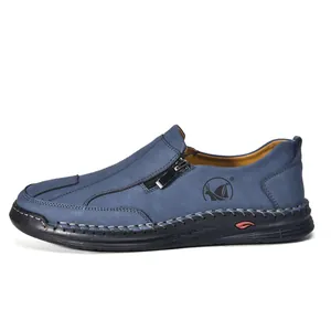 Side profile view of blue hand-stitched men's casual shoes with side zipper detail