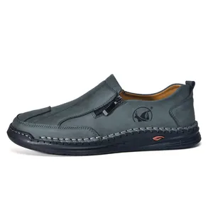 Detail view of men's casual leather shoes with hand-stitched sole and side zipper