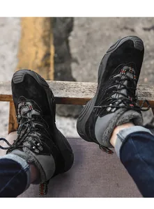 Close-up of men's black winter snow boots with warm fleece lining and sturdy soles.