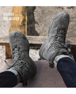 Detailed view of grey fleece-lined winter snow boots for men in a rugged outdoor setting