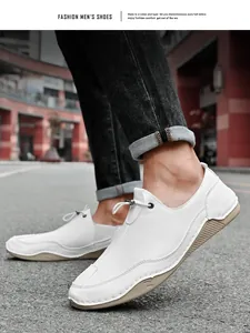 Detailed view of stylish white men's casual flat shoes with decorative lacing