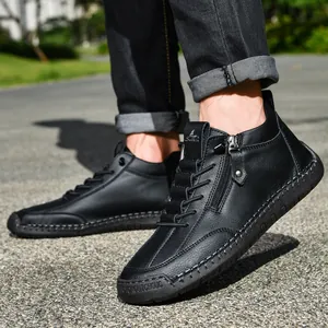 Close-up view of men's black leather Martin boots with side zipper and stitching detail