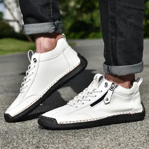 Men's white leather Martin boots featuring side zipper and black hand-stitched soles