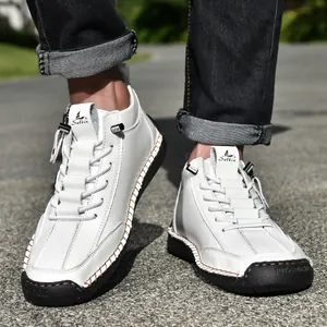 Detail shot of white men's casual Martin boots with side zipper and rubber sole.