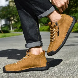Side-angle detail of brown men's Martin short boots with side zipper and rubber sole