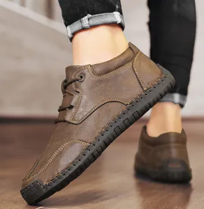 Close-up detail of brown men's casual leather boots featuring rugged contrast stitching
