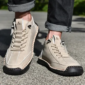 Detailed look at men's khaki suede Martin boots with side zipper and hand-stitched sole.