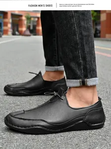 Side view of black men's outdoor casual leather shoes on an asphalt street background