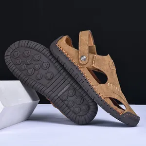 Close-up of men's brown stitched sandals showing durable rubber sole and side detail