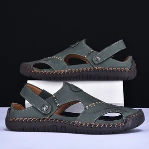 Close-up side profile of dark green leather-textured sandals featuring hand-stitched seams