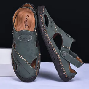 Close-up of hand-stitched dark green men's leather sandals with breathable design