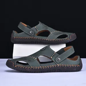 Side view detail of dark green men's leather sandals with brown hand-stitched accents