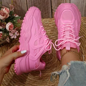 Close-up detail van roze chunky sneakers met dikke plateauzolen en mesh-materiaal