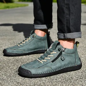 Detail of men's blue-green casual Martin boots with side zipper and lace-up design.