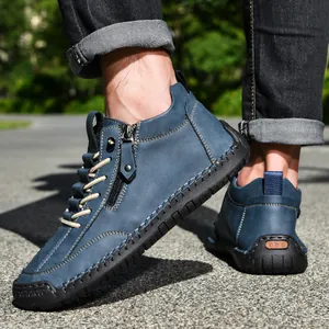 Detailed macro shot of blue men's low-top casual boots featuring side zipper and stitching