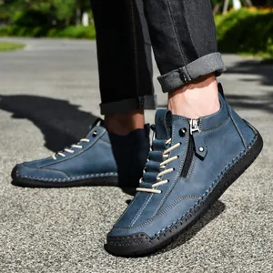 Close-up detail of blue men's low-top casual Martin boots with side zipper and hand stitching