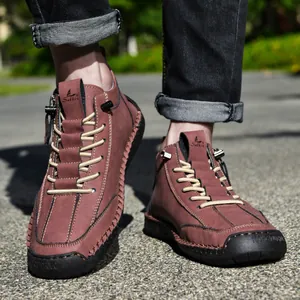 Close-up view of men's casual leather boots featuring a side zipper and contrast stitching