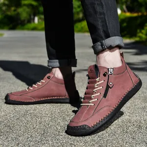 Close-up of stylish men's burgundy Martin boots featuring a side zipper and classic lace-up design
