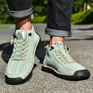 Detailed view of mint green men's casual Martin boots featuring hand-stitched edges