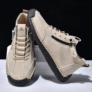 Detailed view of the side zipper and hand-stitched sole on the men's casual beige boots.