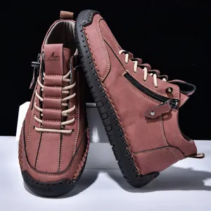 Detailed view of brown men's casual boots featuring side zipper and hand-stitched sole.