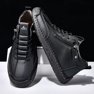 Close-up detail of black leather men's ankle boots featuring a functional side zipper
