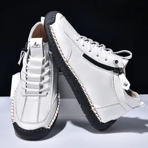 Detail of white men's leather boot featuring functional side zipper and stitching