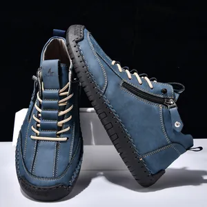 Detail view of blue men's casual mid-top Martin boots with side zipper and laces