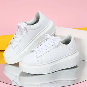 Gedetailleerde opname van witte platform sneakers op een gespiegelde glazen ondergrond