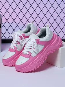 Detail view of pink and white chunky platform sneakers with breathable perforations