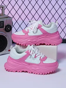 Pink and white platform dad shoes on retro studio background