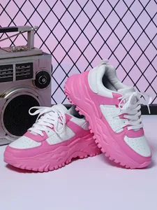 Detail view of pink and white chunky platform sneakers with breathable perforations