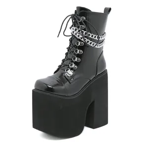 Women's black patent leather platform boots with chunky high heels and chain detail