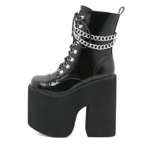 Side view of black patent leather platform combat boot with silver chain details