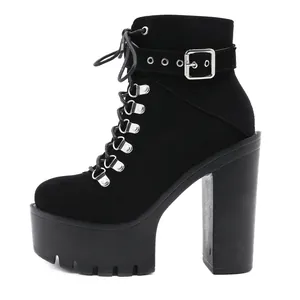Detail of black suede platform ankle boots with high chunky heel and buckle strap