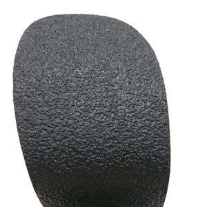 Macro view of the black granular textured material on high-heel platform fashion boots