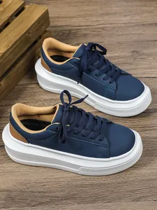 Gedetailleerd zicht op donkerblauwe dames sneakers met plateau en dikke witte zolen