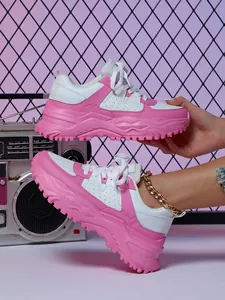 Detailed view of pink and white chunky platform sneakers for a trendy casual look.