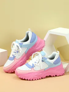 Detailed view of chunky pastel sneakers with pink and blue panels and thick soles