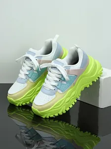 Detail view of chunky lime green and pastel platform dad shoes with breathable mesh