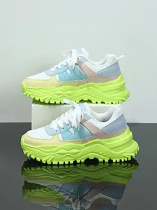 Close-up detail of multi-color thick-sole chunky sneakers with neon green platform