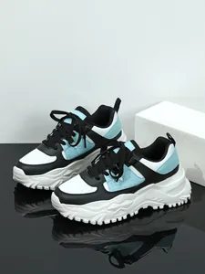 Perspective view of trendy platform sneakers in white black and light blue colorway