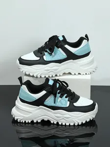 Detailed side view of breathable chunky sneakers in blue and black with platform soles