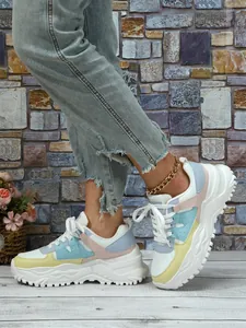 Side view of chunky platform sneakers with colorful pastel panels and white laces