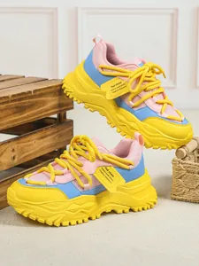 Detailweergave van kleurrijke dames mesh sneakers met dikke gele plateauzool