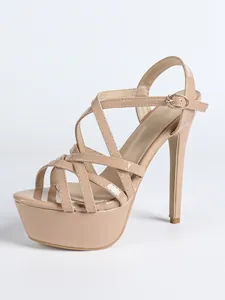 Elegant nude platform sandals featuring thin high heels and cross strap design for party wear